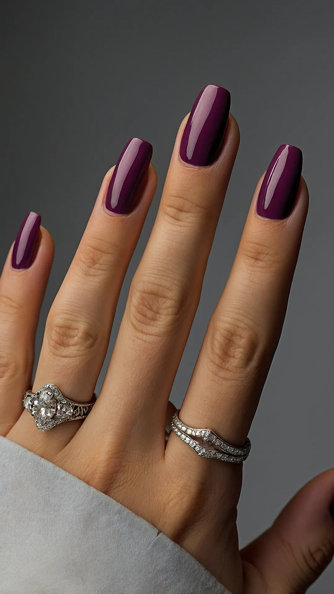 <p>Feeling the crisp autumn air and dreaming of cozy sweaters? Your nails can totally get in on that vibe! Just look at that rich, deep plum shade – it’s like a fancy, grown-up version of all the gorgeous fall colors, ready to make a statement whether you're acing a test or just scrolling through TikTok. These aren't just nails; they're a tiny, glamorous party happening right on your hand, probably making all your pens a little jealous. It's the perfect way to embrace pumpkin spice season without actually having to *be* a pumpkin.</p><p>And hold up, because those gold accents are totally next level! Who needs a sparkly crown when you've got geometric gold lines and swirly patterns right on your nails? It's like your fingers are wearing tiny, epic pieces of art, giving off major sophisticated vibes. Paired with that dazzling ring, your hand is basically saying, 