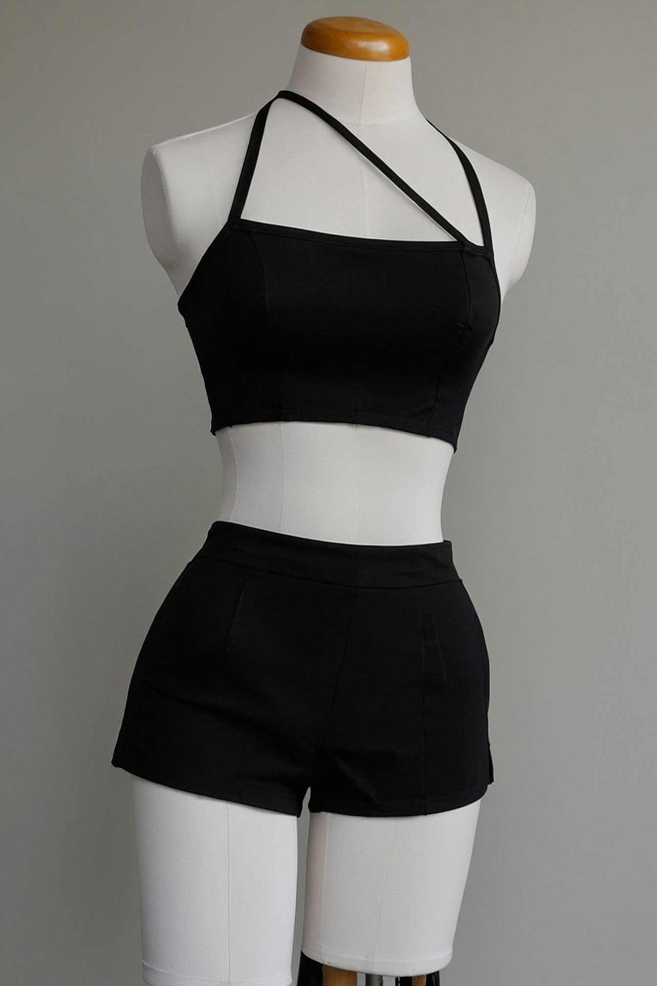 Minimalist black halter crop top and tailored shorts