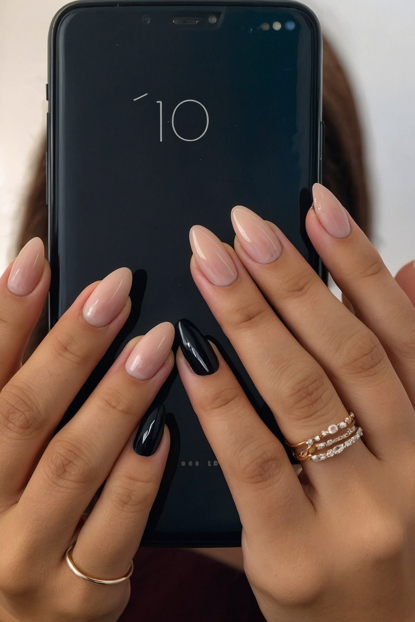 Close-up on Almond Nails with Black and Nude Polish
