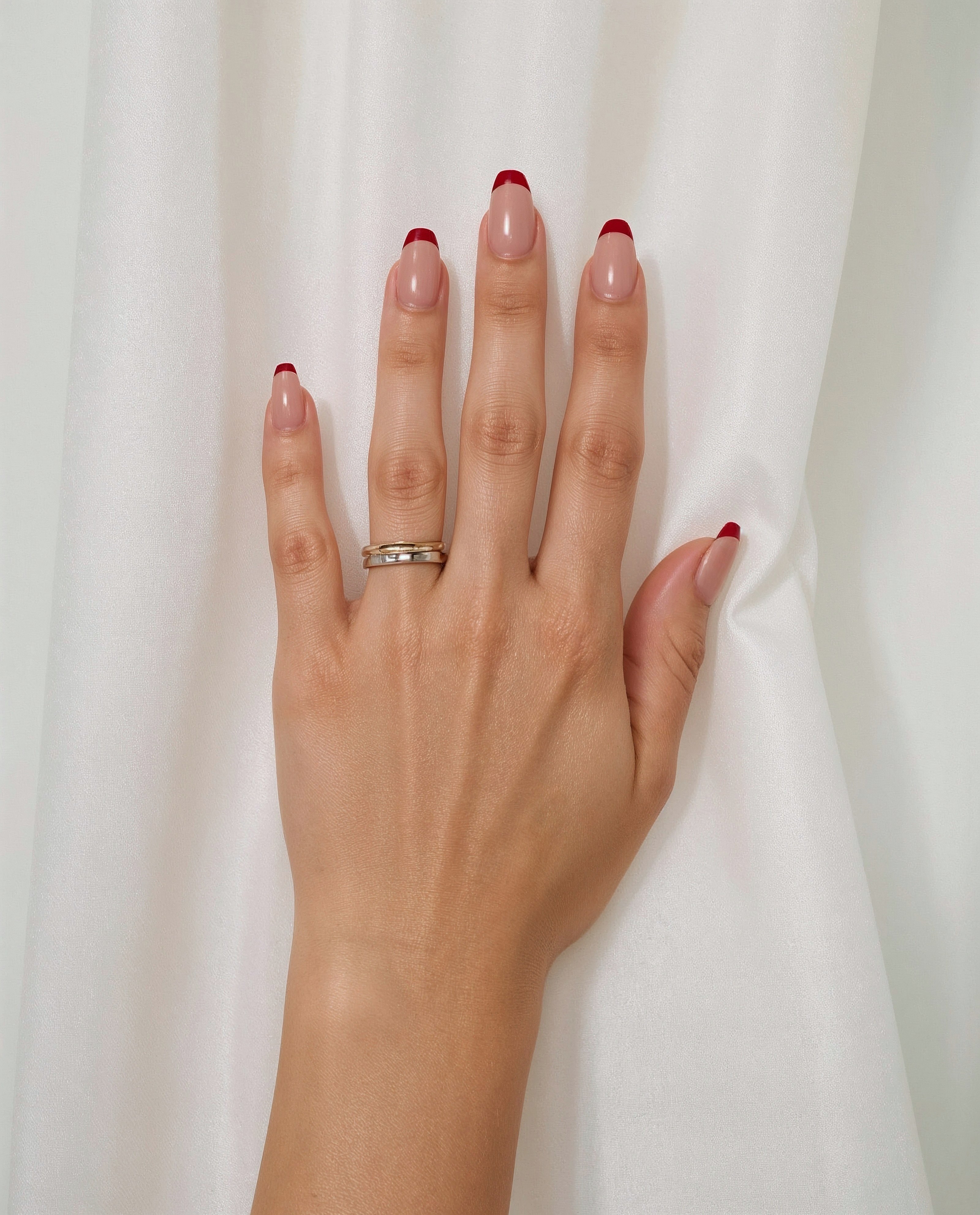 Close-up on Almond Nails with Bold Red French Tips