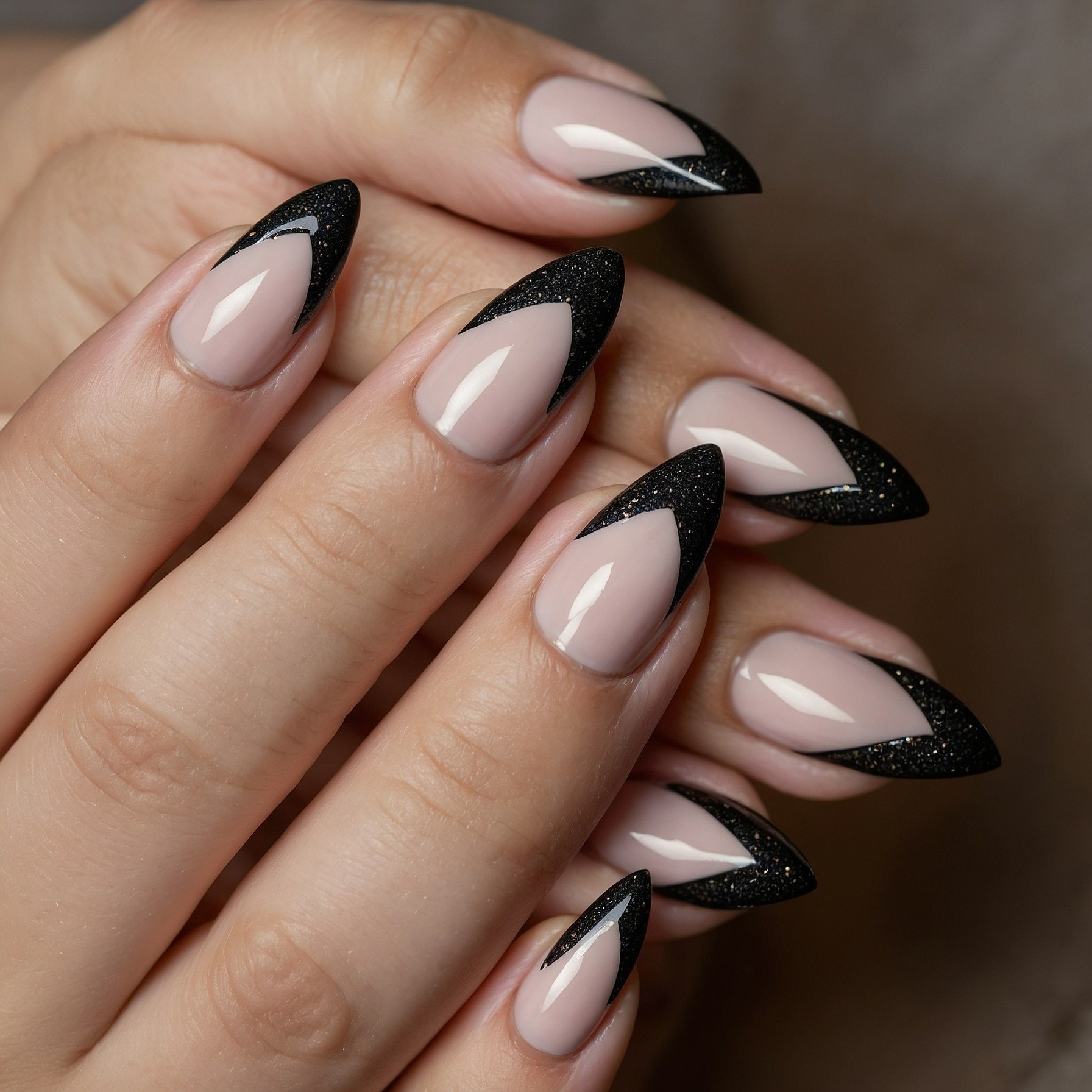 Close-up of almond nails with glitter french tips