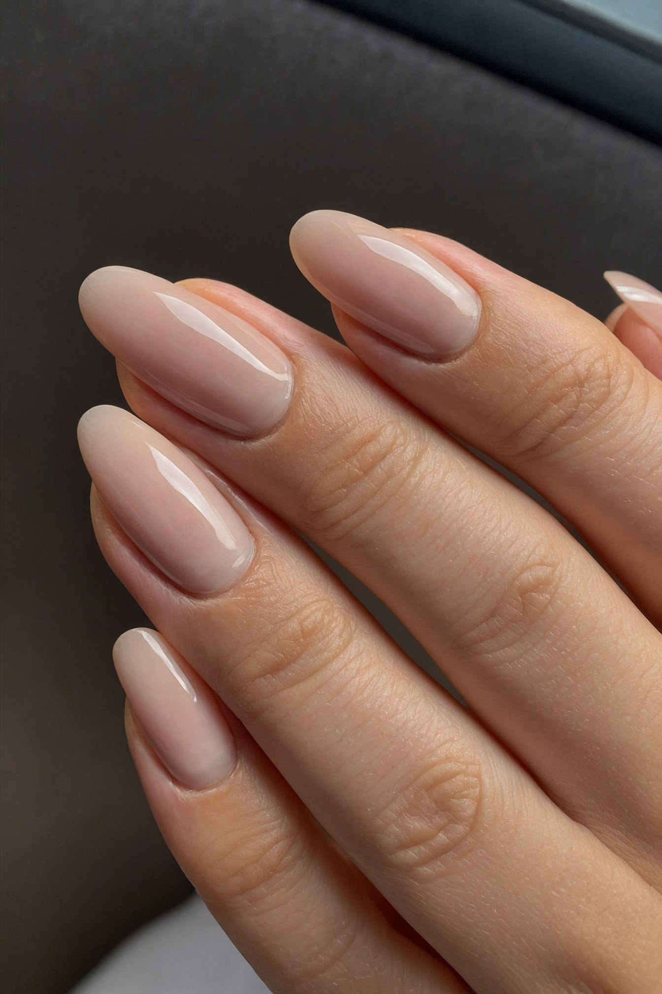 Almond-shaped nude nails with subtle sheen