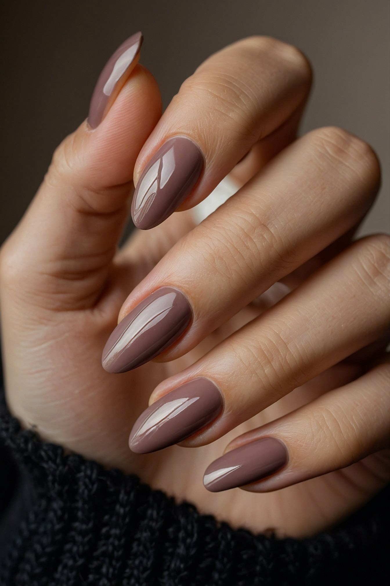 Close-up of almond-shaped nails in taupe