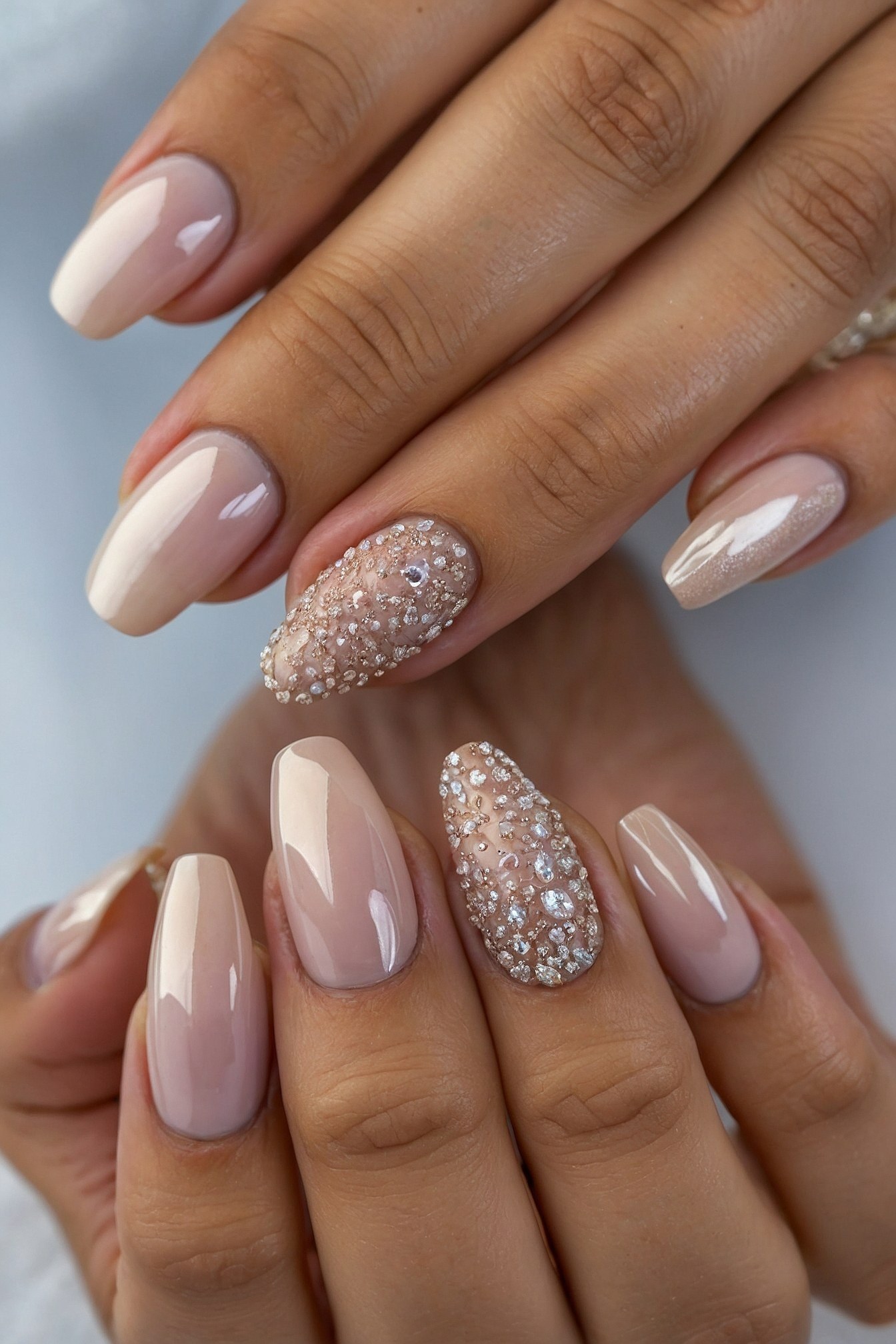 Almond nails with subtle ombre and jewel accents