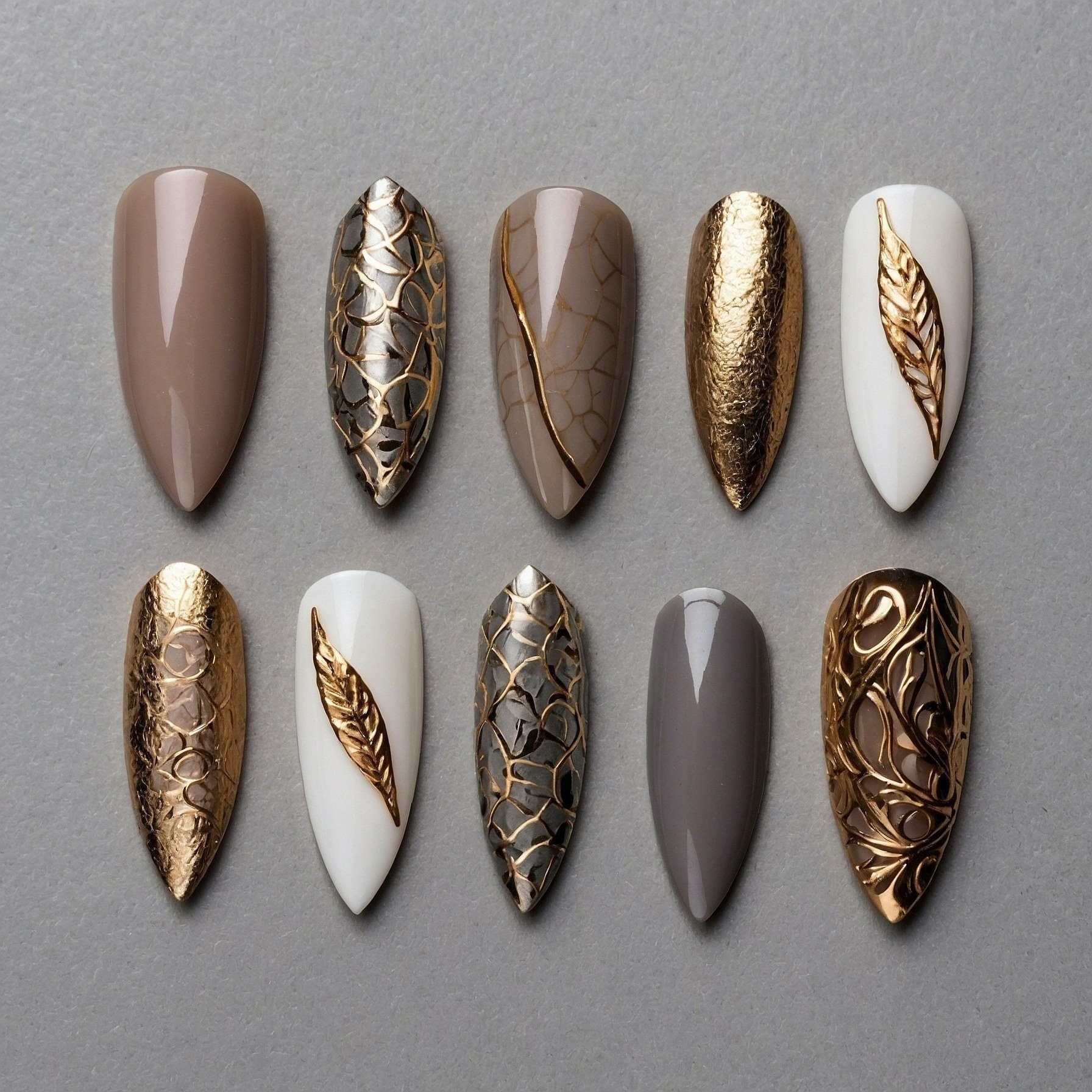 Almond-shaped nails with rich gold and taupe finishes