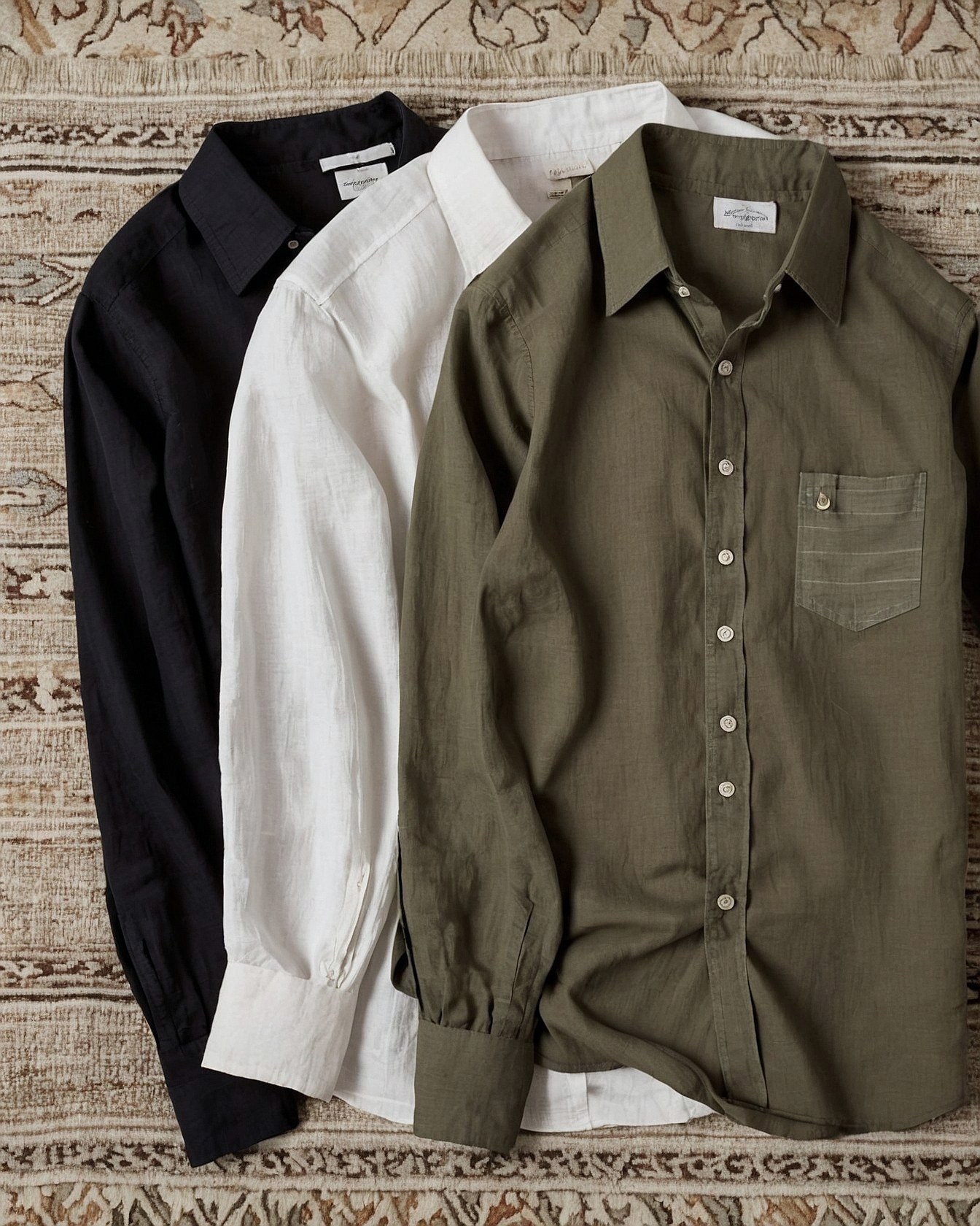 Three Neutral Linen Shirts on a Textured Rug