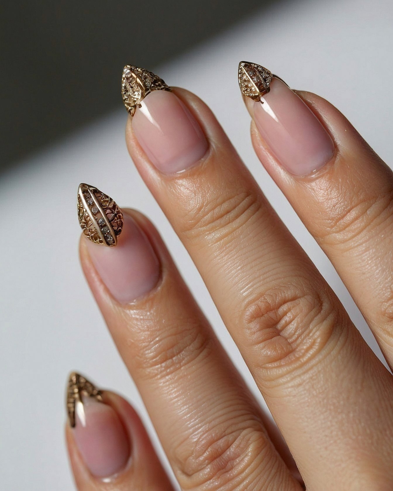 Almond-shaped gold tips with diamond accents