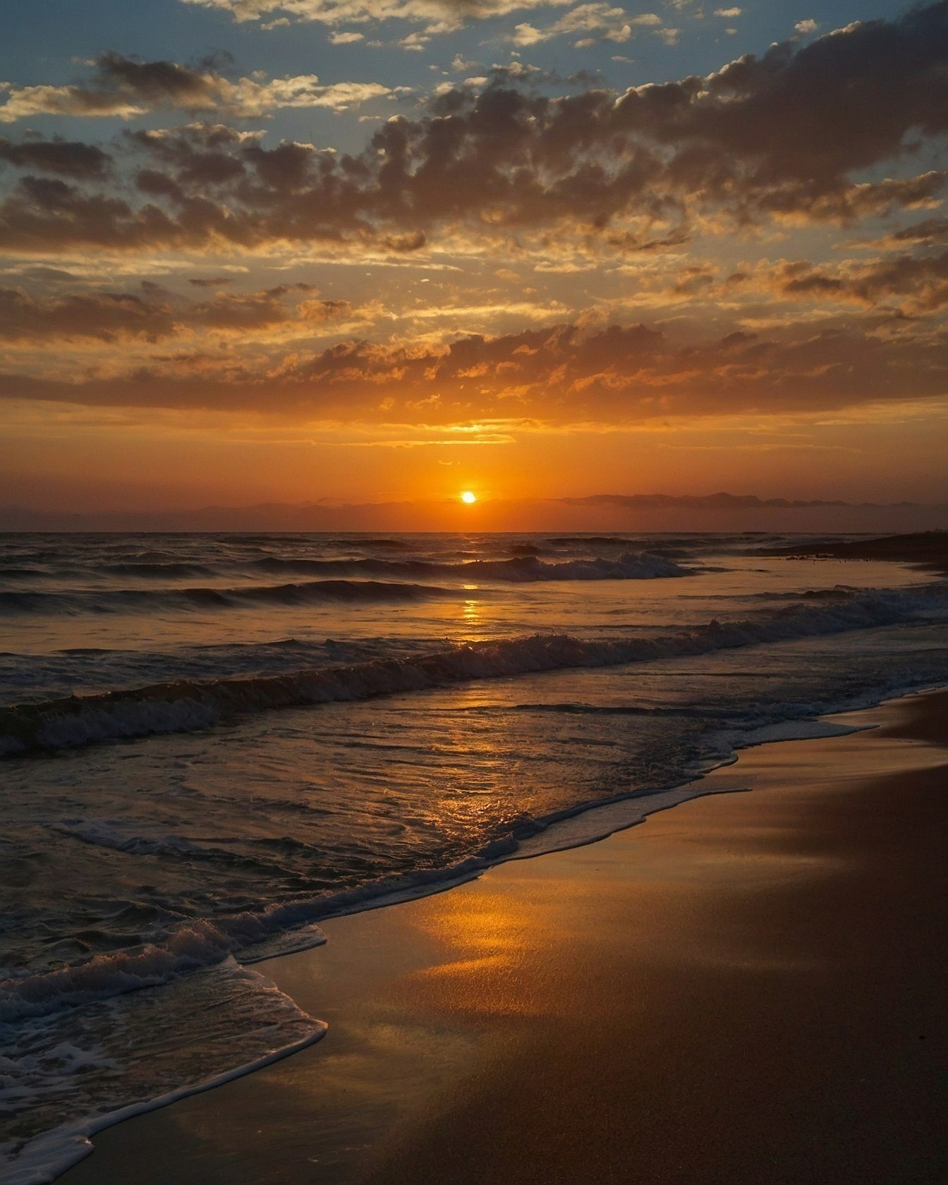 Golden hour glow reflecting on wet sand