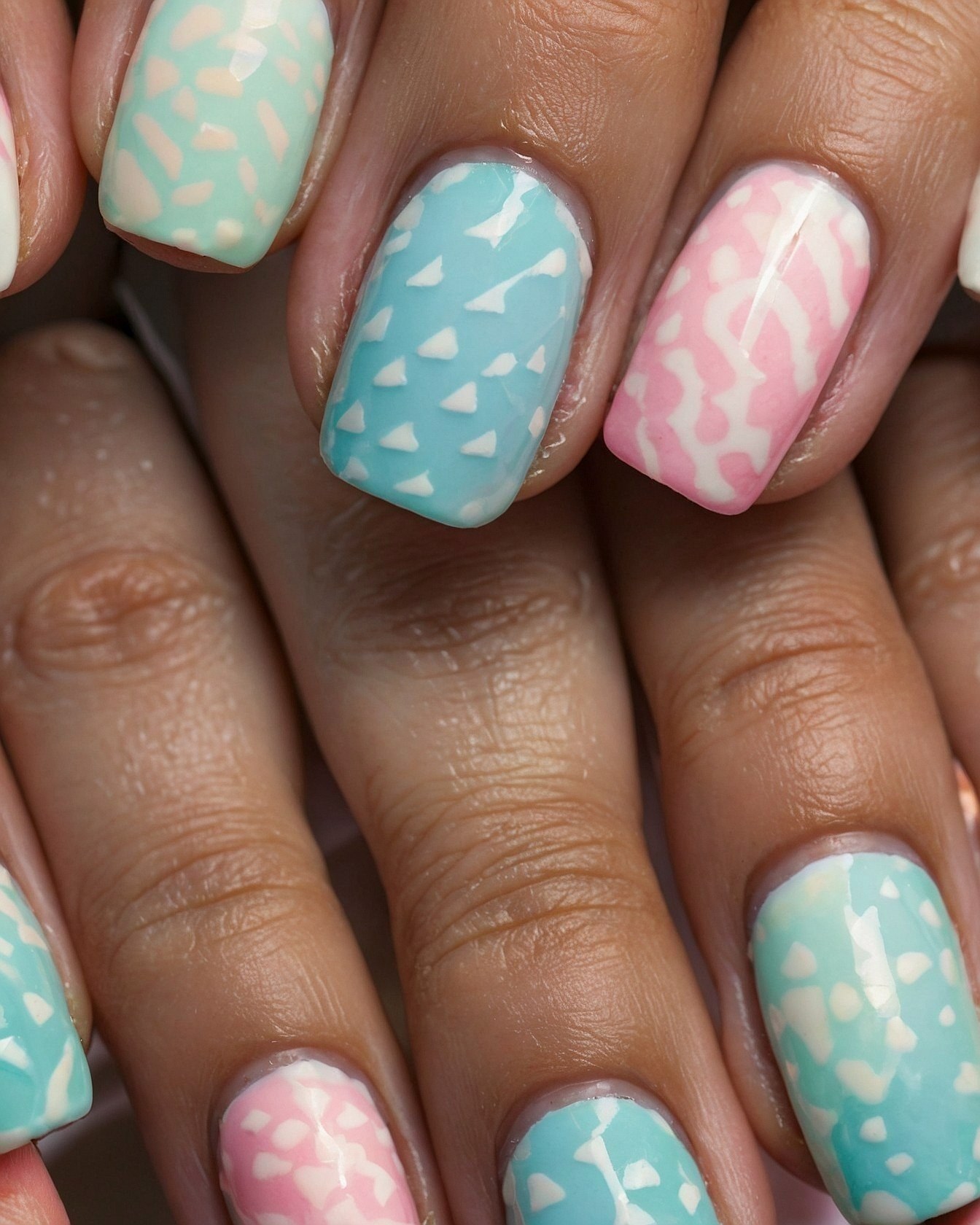 Close-up of pastel tips with graphic white designs