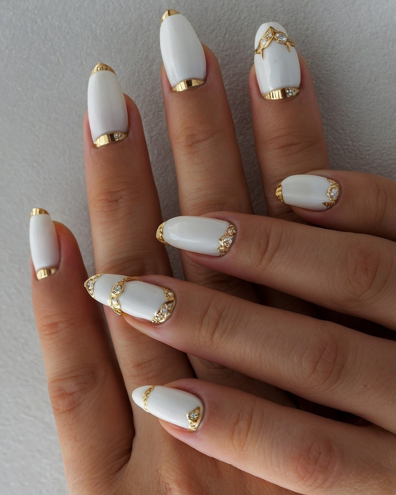 White and Gold Almond Nails With Gem Accents