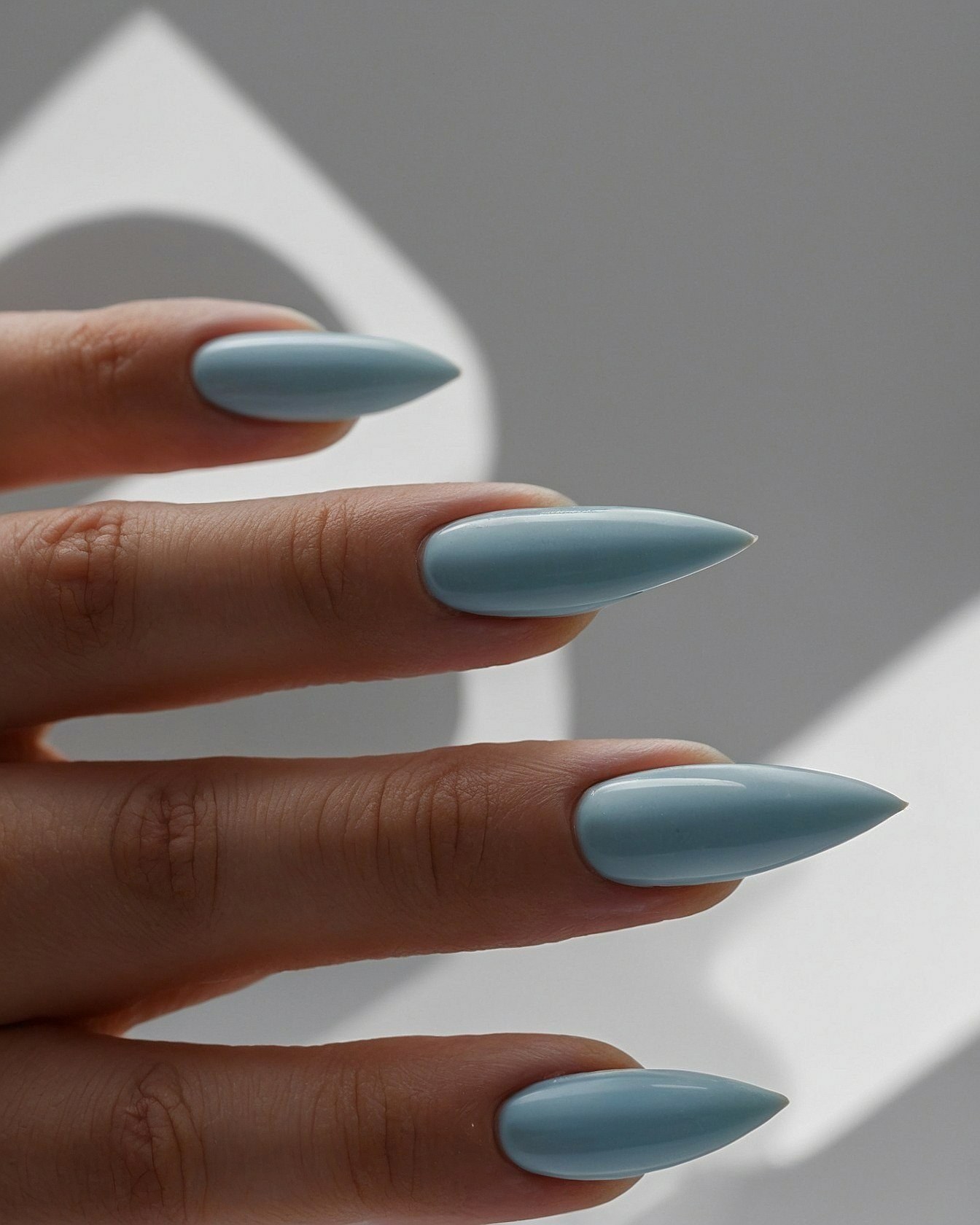 A Close-up of Dusty Blue Stiletto Nails