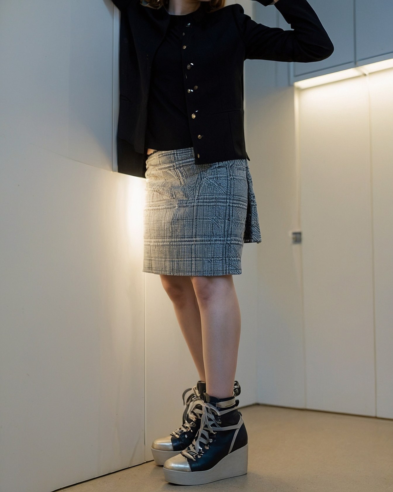 What makes this plaid skirt and platform boot pairing so striking?