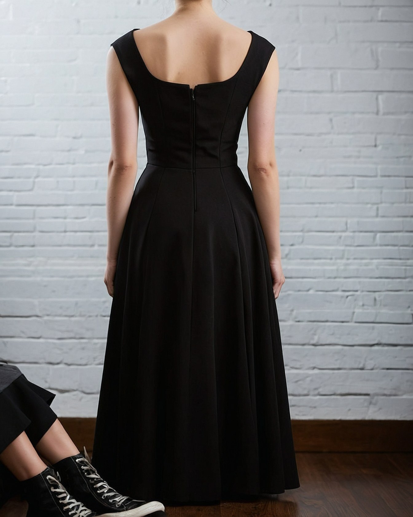 Back view focus: A classic black dress with modern edge