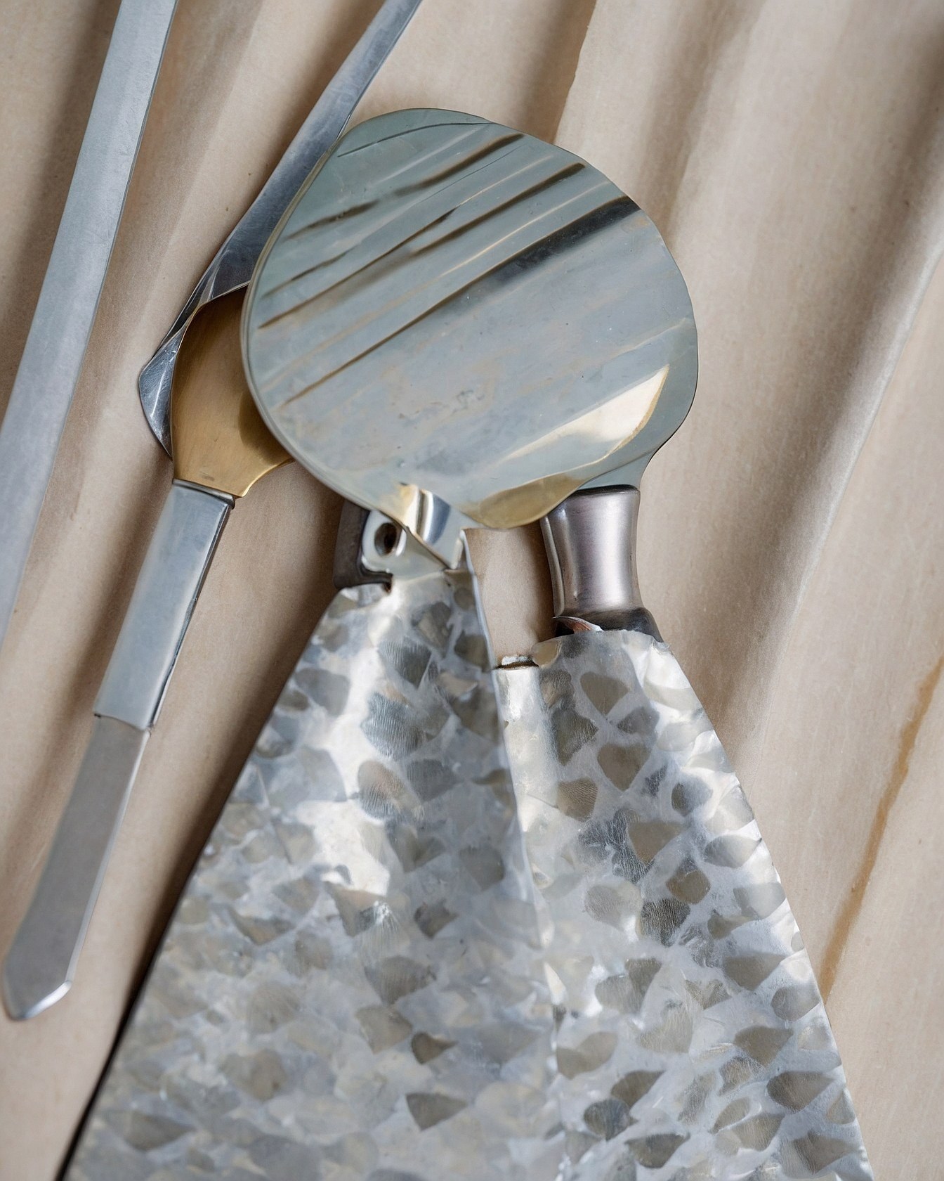 What gives this metallic art piece its captivating sheen?