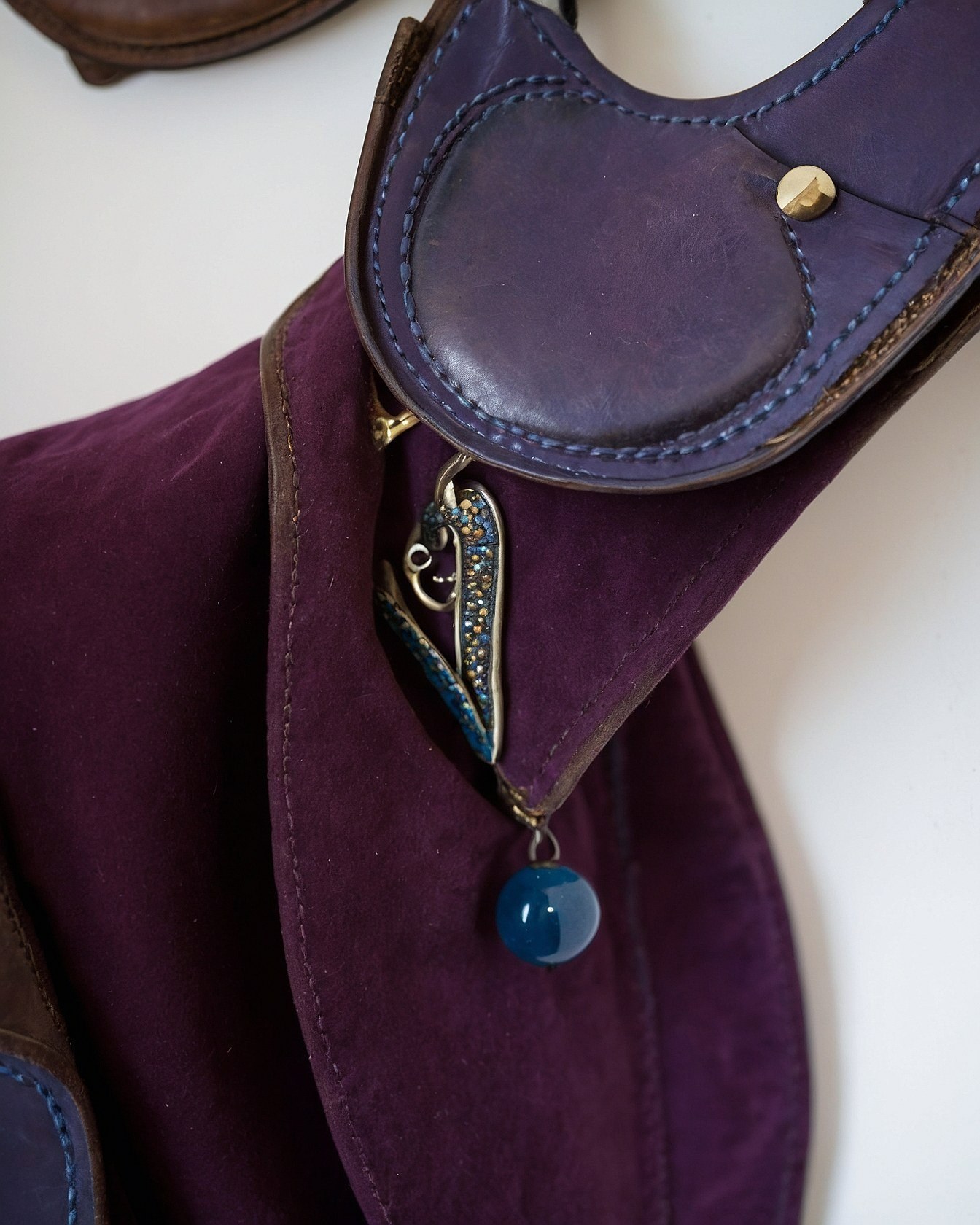 Close-Up of Saddle Adorned with a Blue Charm