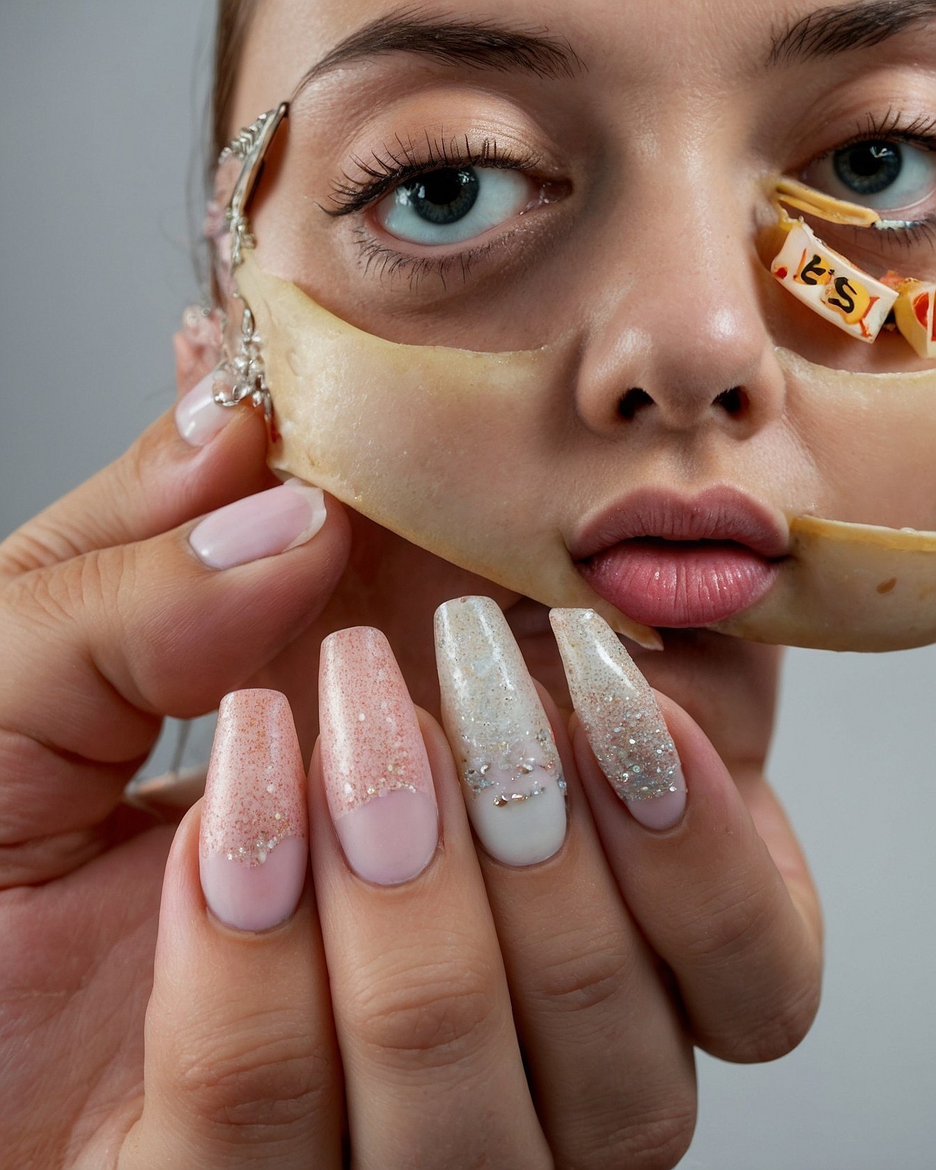 Close-up of Abstract Face Art and Glitter Nails
