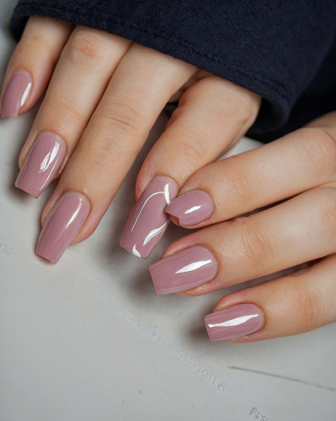 Hands Displaying Muted Rose Nails with White Swirl Accent