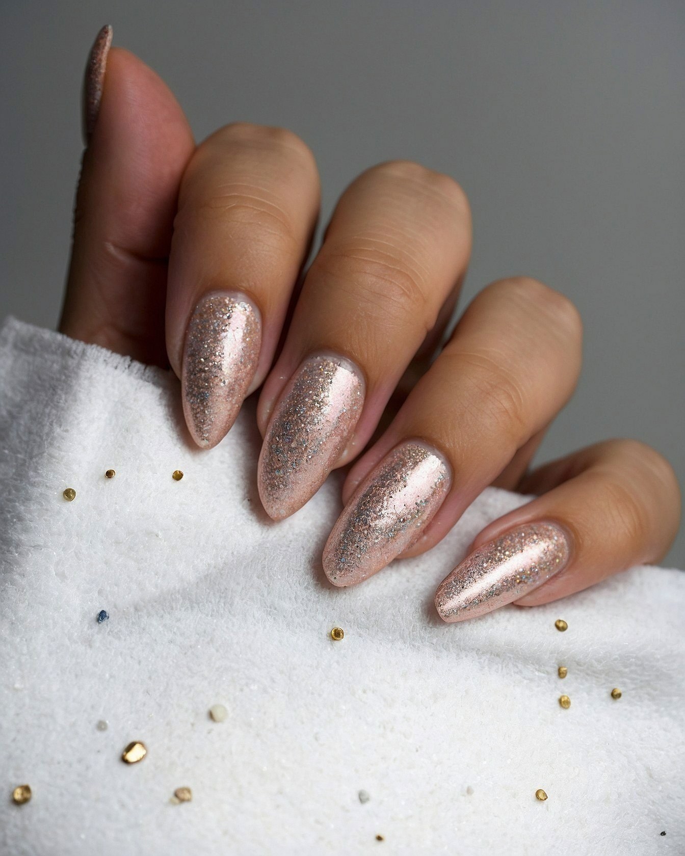 Sparkling Almond Nails on Soft White Fabric