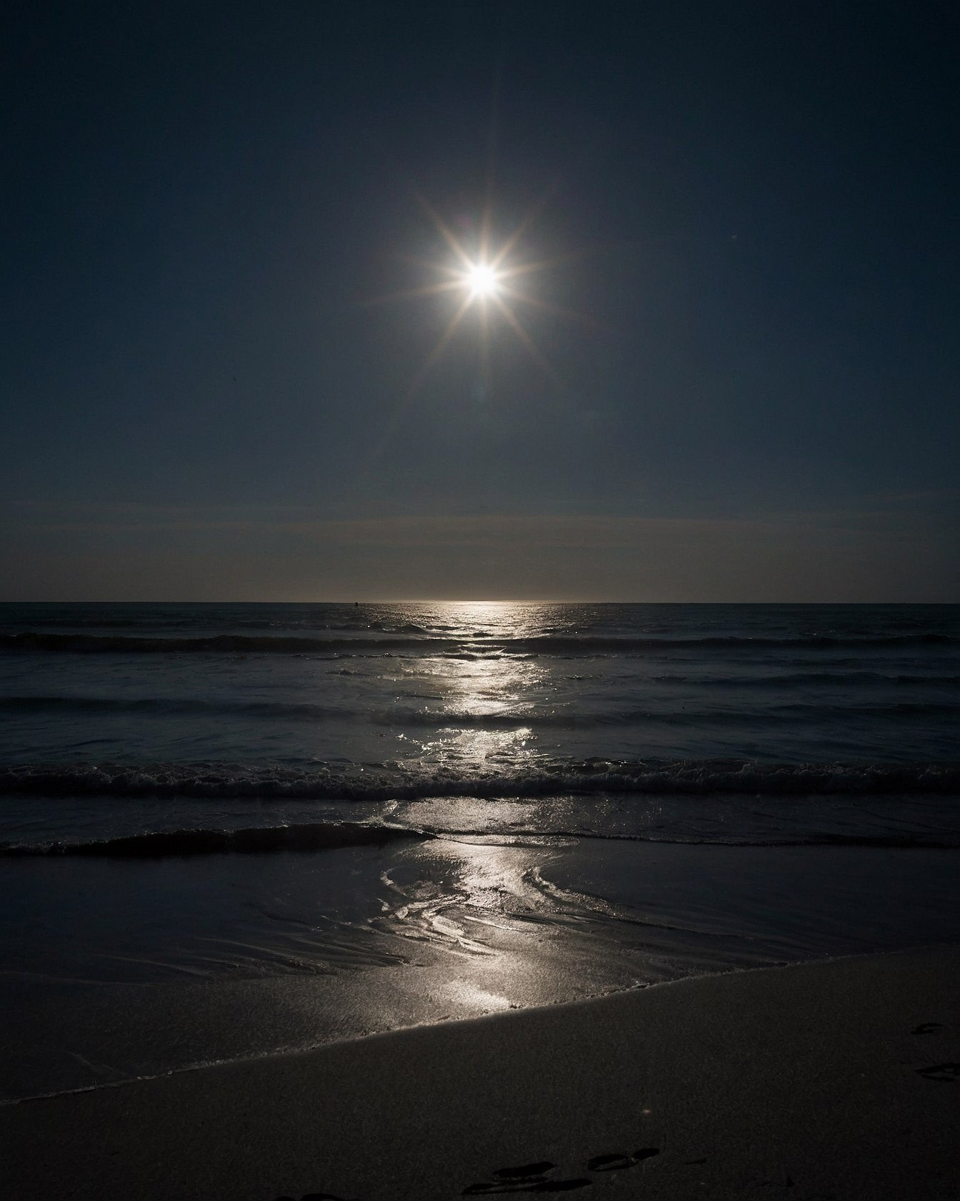 Low Angle of Sunburst Over Ocean Waves