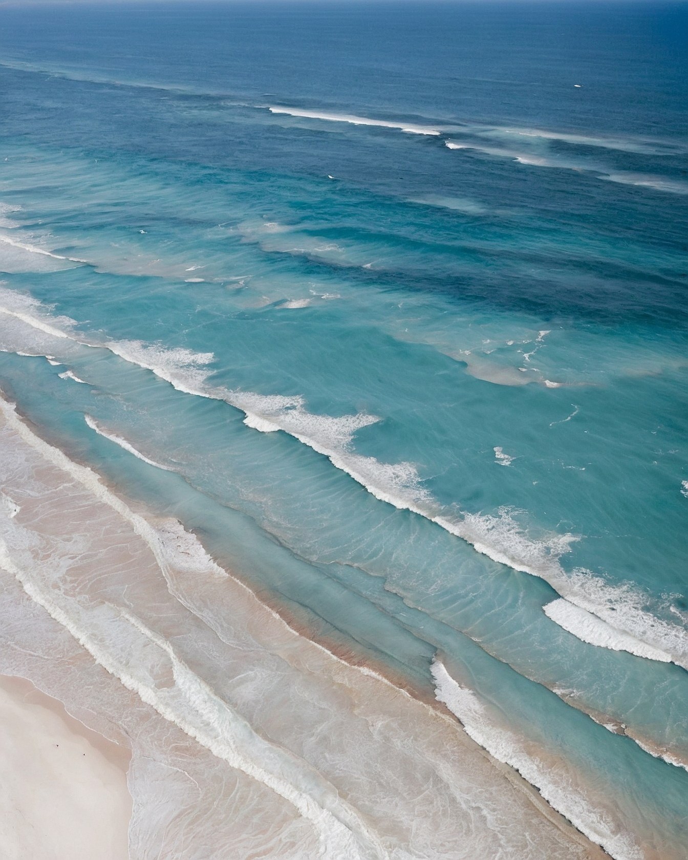 Aerial View of Turquoise Waves Breaking on Shore