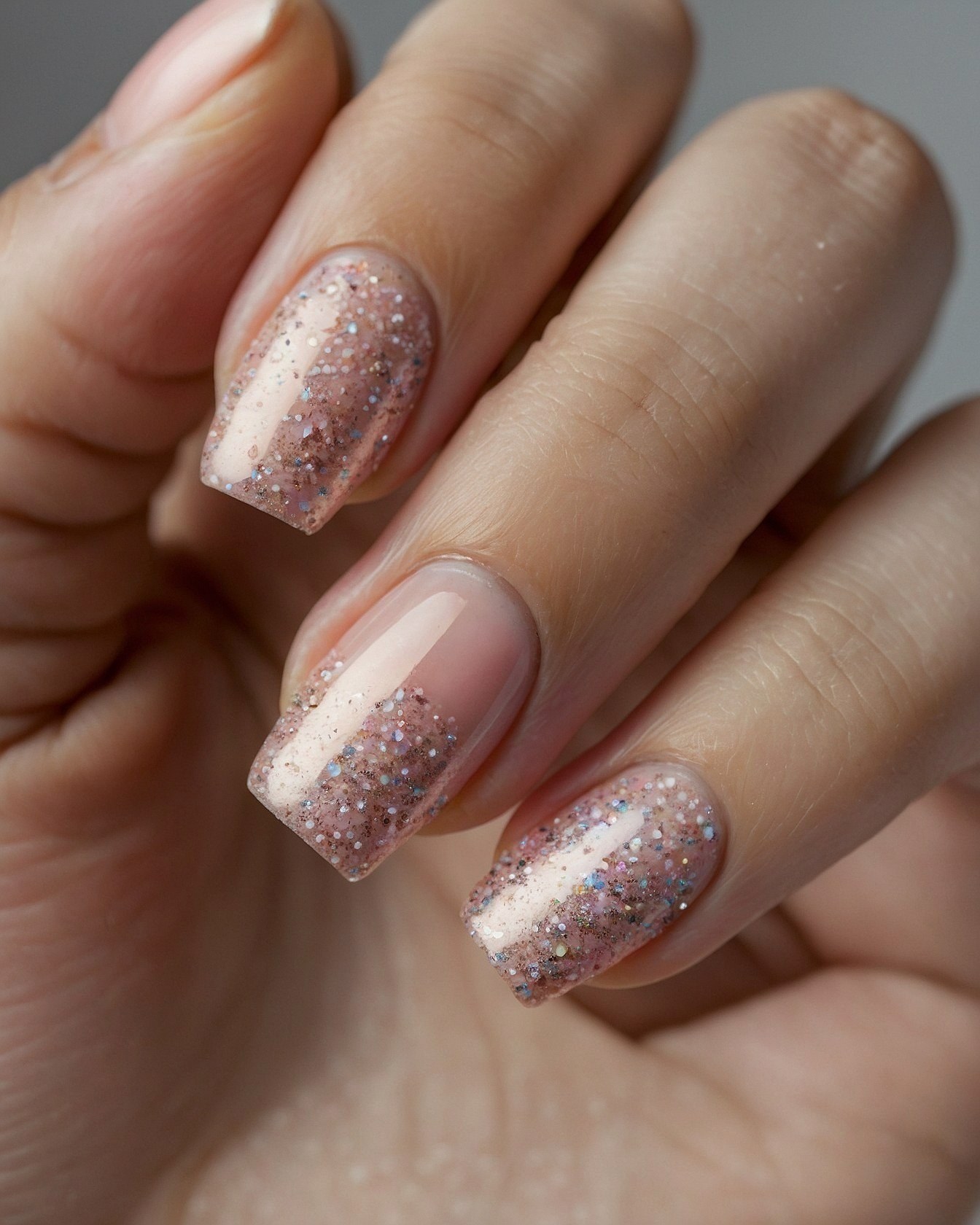 Close-up on a Hand Adorned with Glitter French Tips