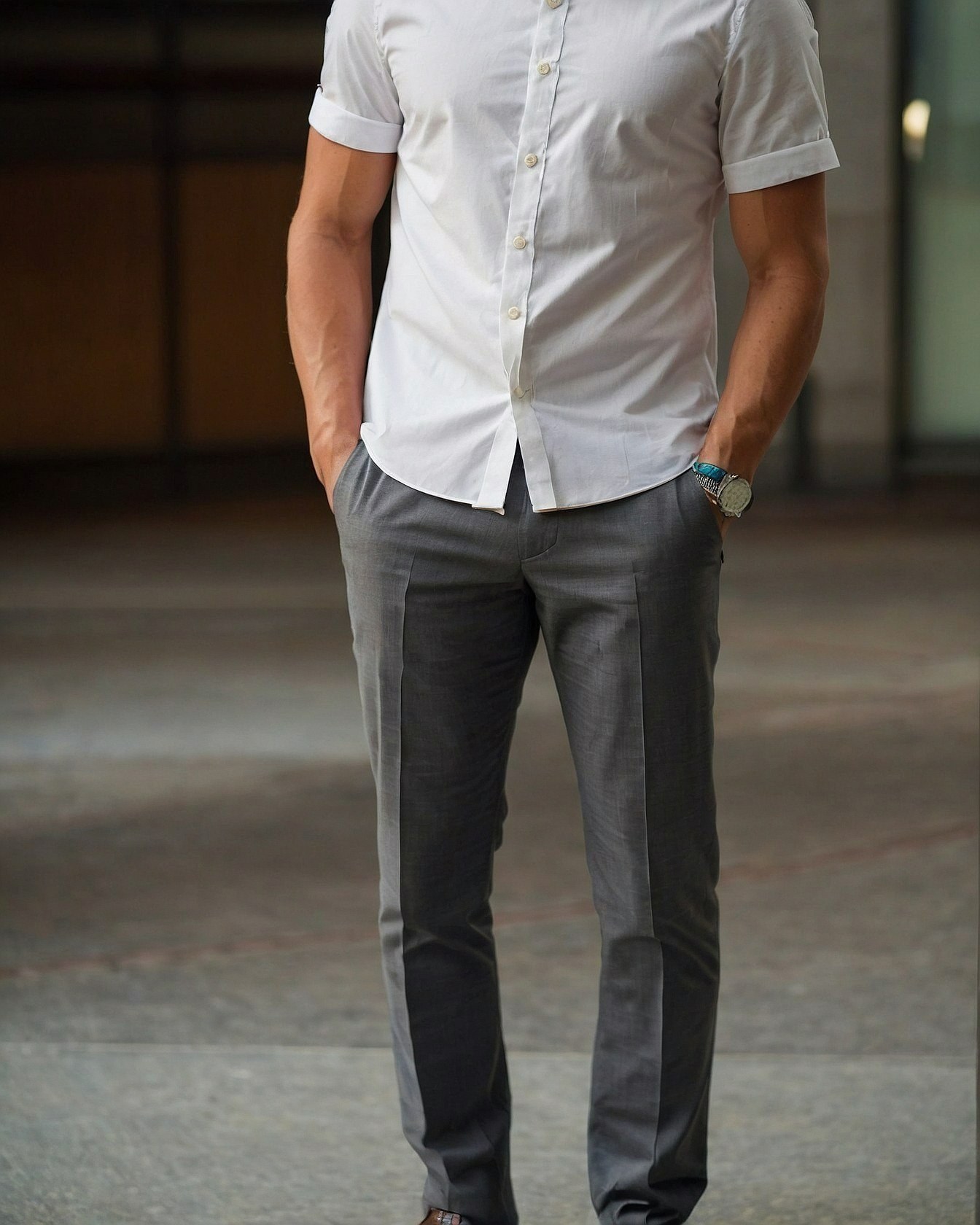 Crisp rolled cuffs meet tailored gray trousers