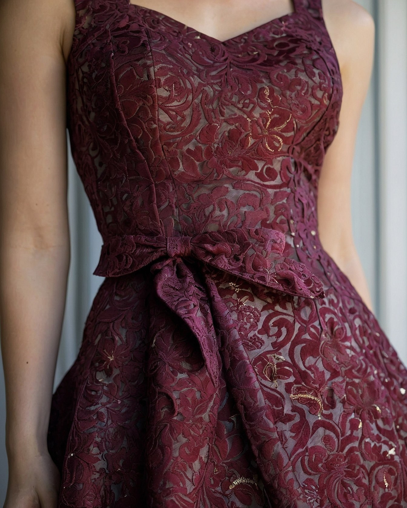 Brocade fabric detail with a tied sash