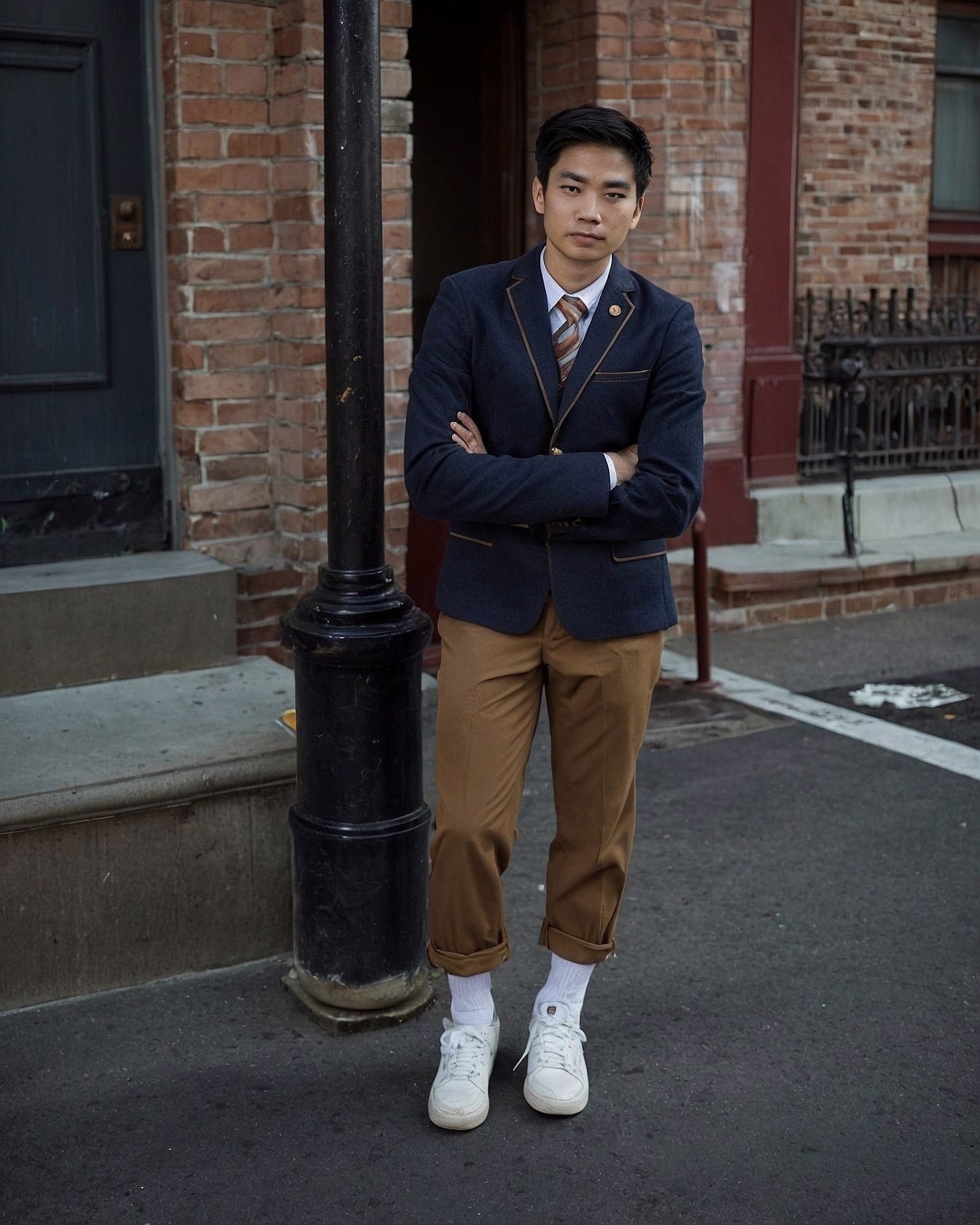 Deep navy, camel tan, and brick red on a city stoop