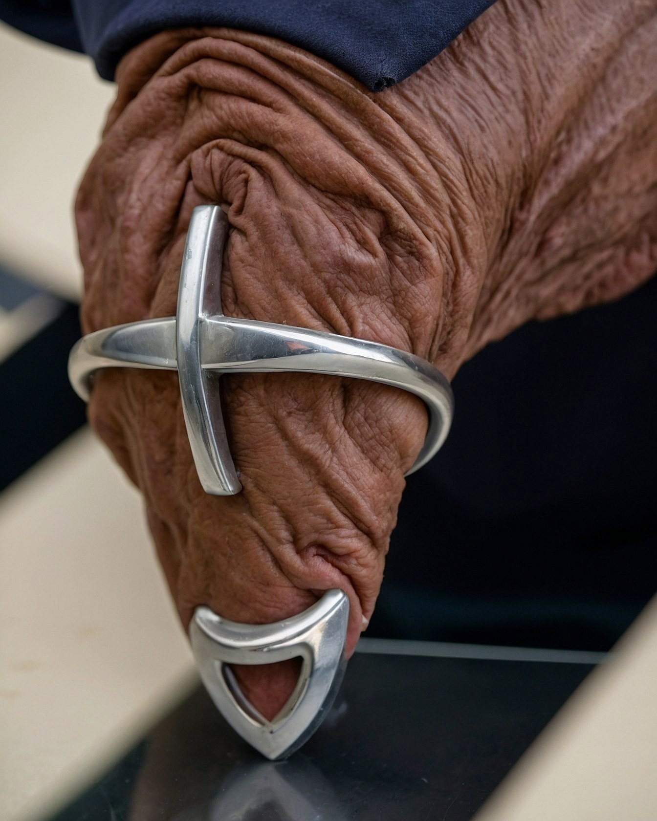 Close-up on silver cuffs and richly toned skin