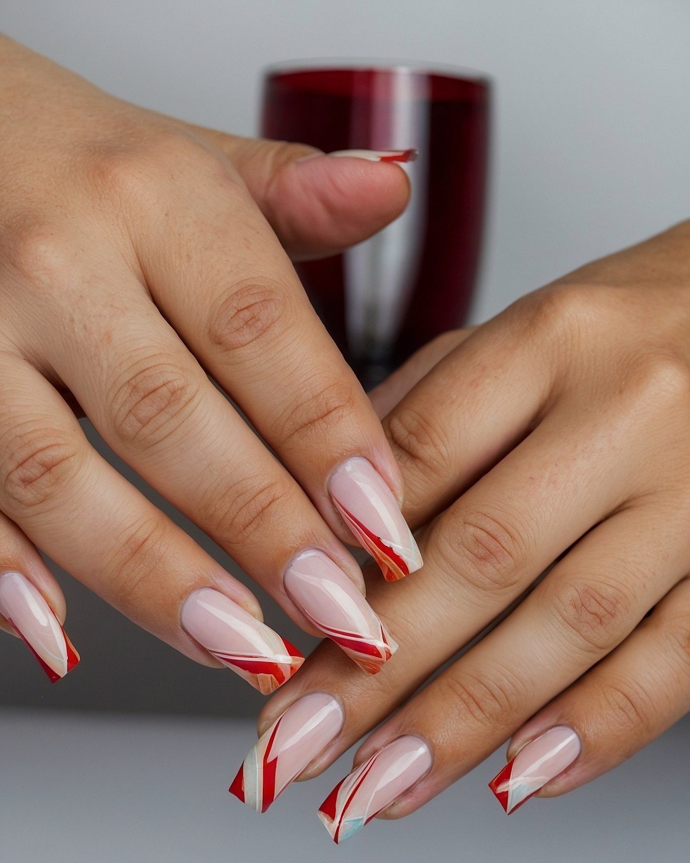 French tip nails with a striped berry red accent