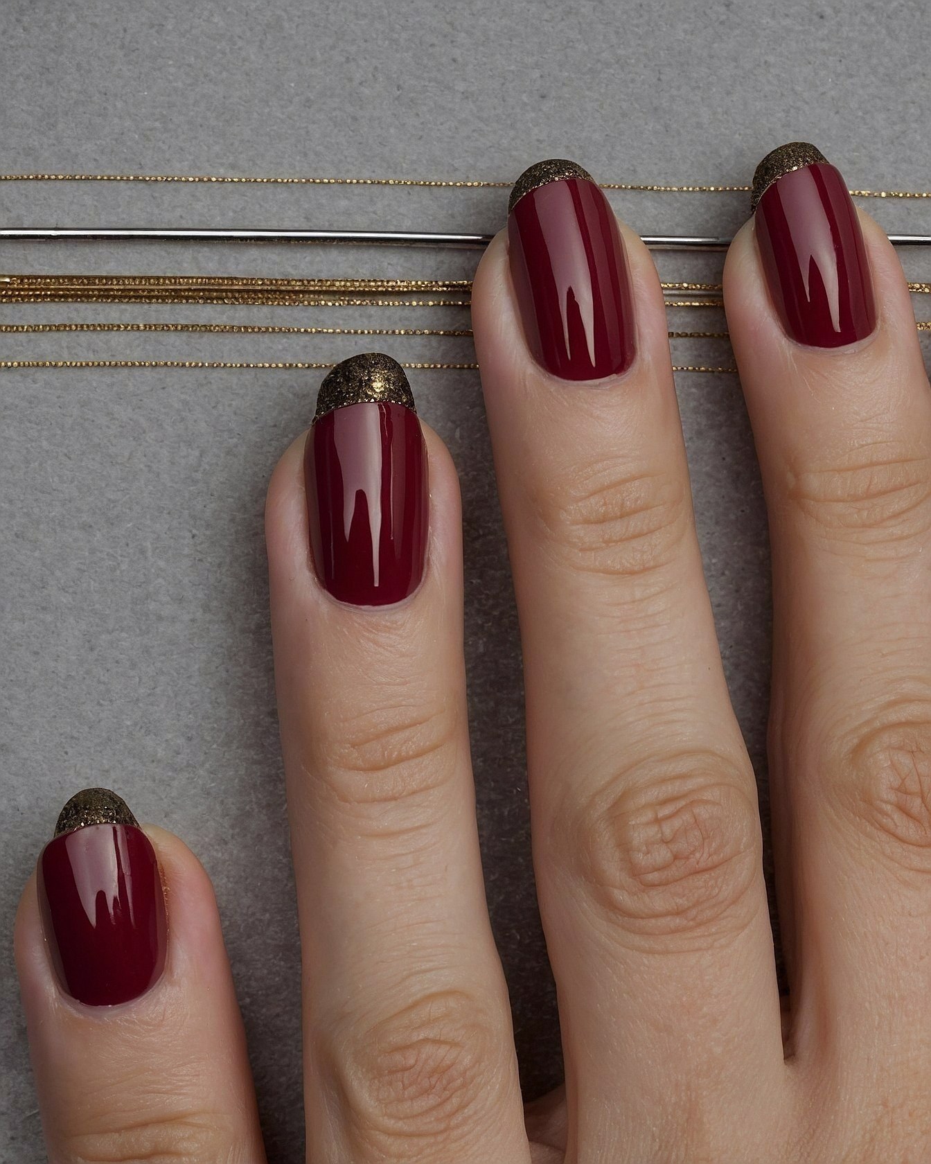 A Quartet of Deep Crimson Almond-Shaped Nails