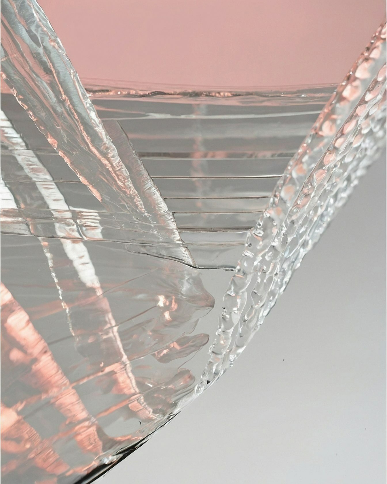 Reflective surface catching soft rose and silver light