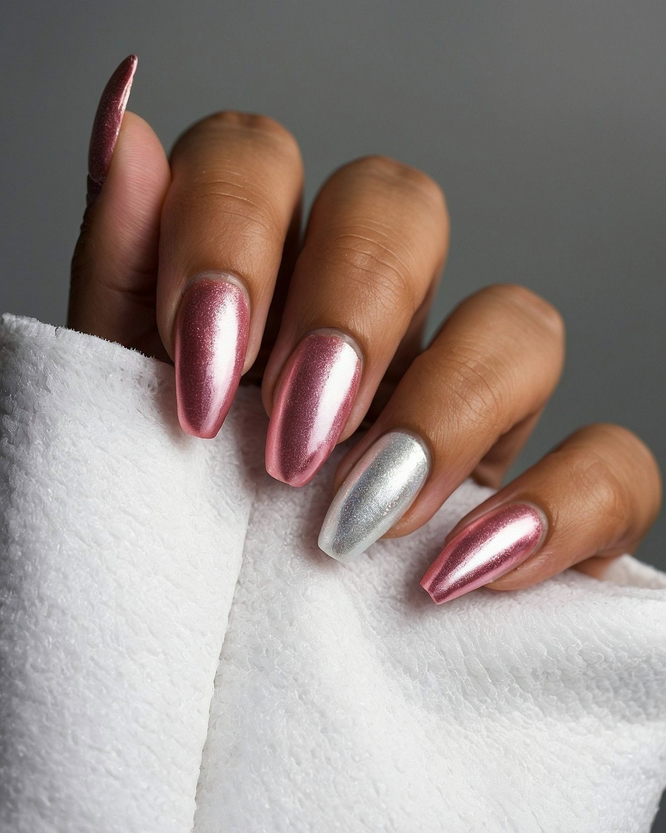 Chrome Pink and Silver Nails Against White Terrycloth