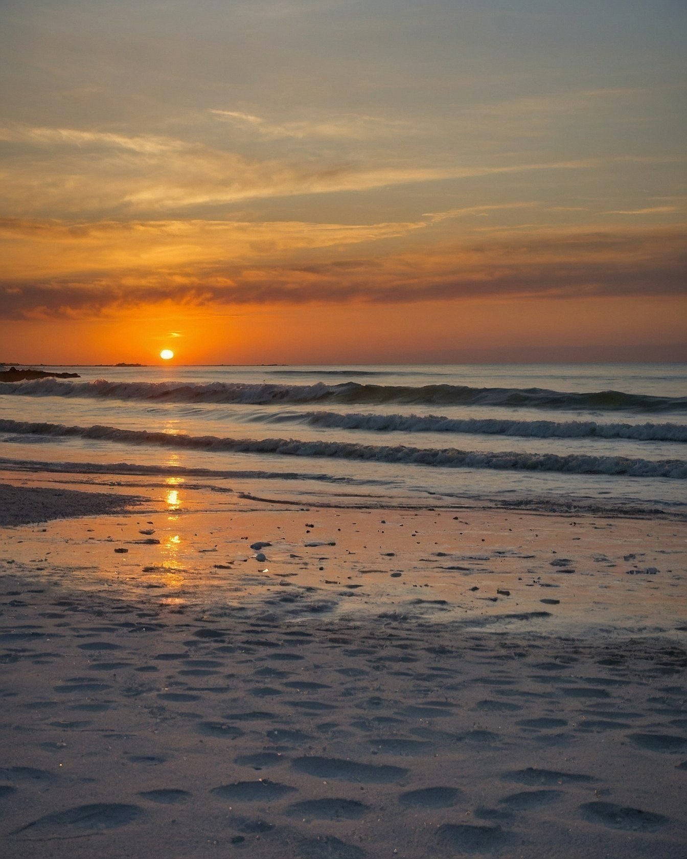 Warm Sunset Over Gentle Waves and Sand