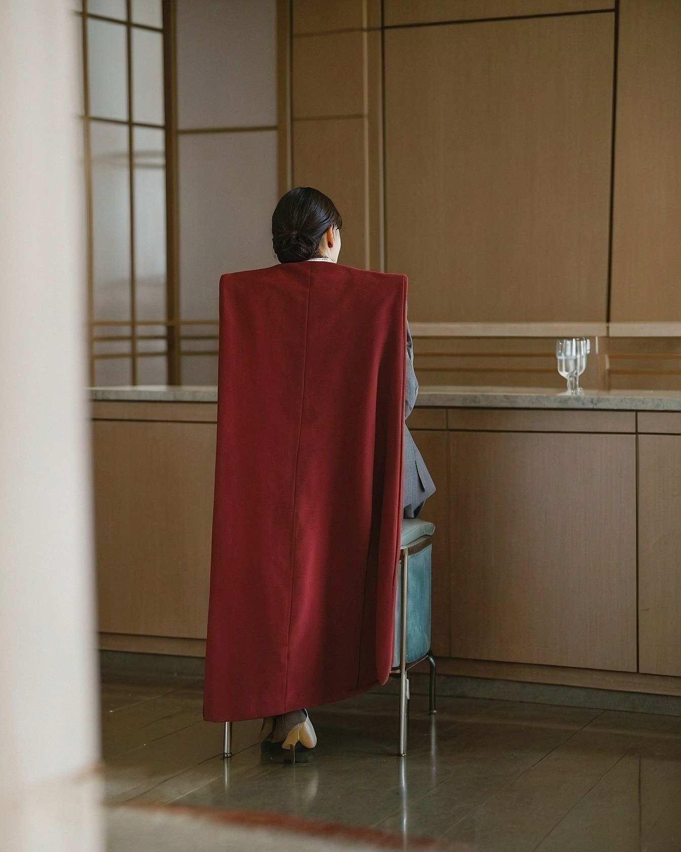 A Ruby Red Cape Over a Slate Grey Ensemble