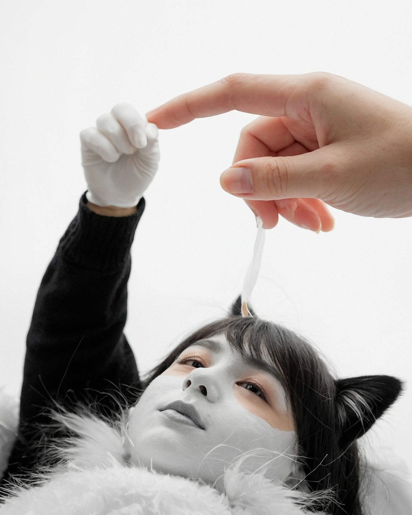 Monochromatic makeup with cat ears and white gloves