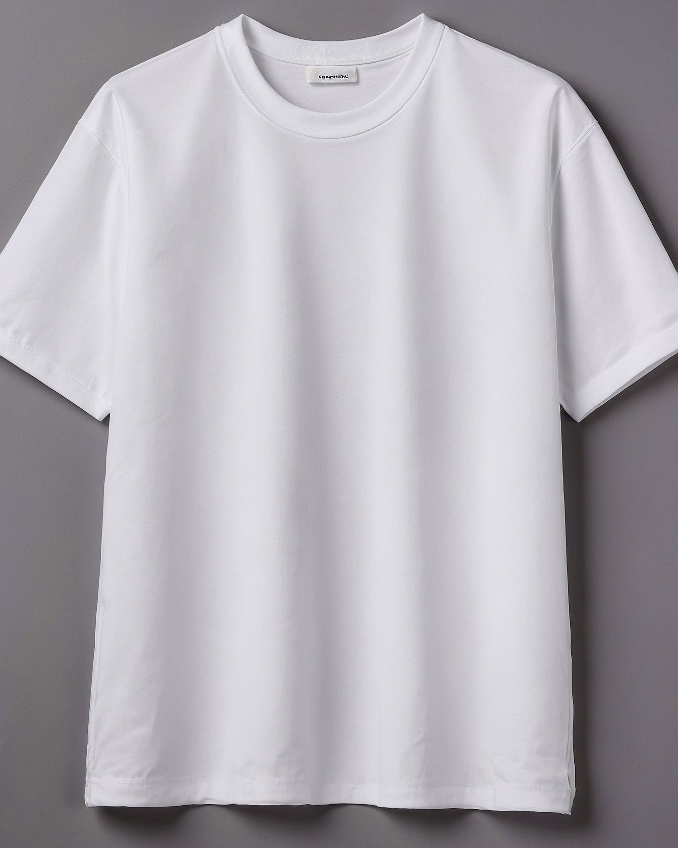Classic white tee against a muted slate background