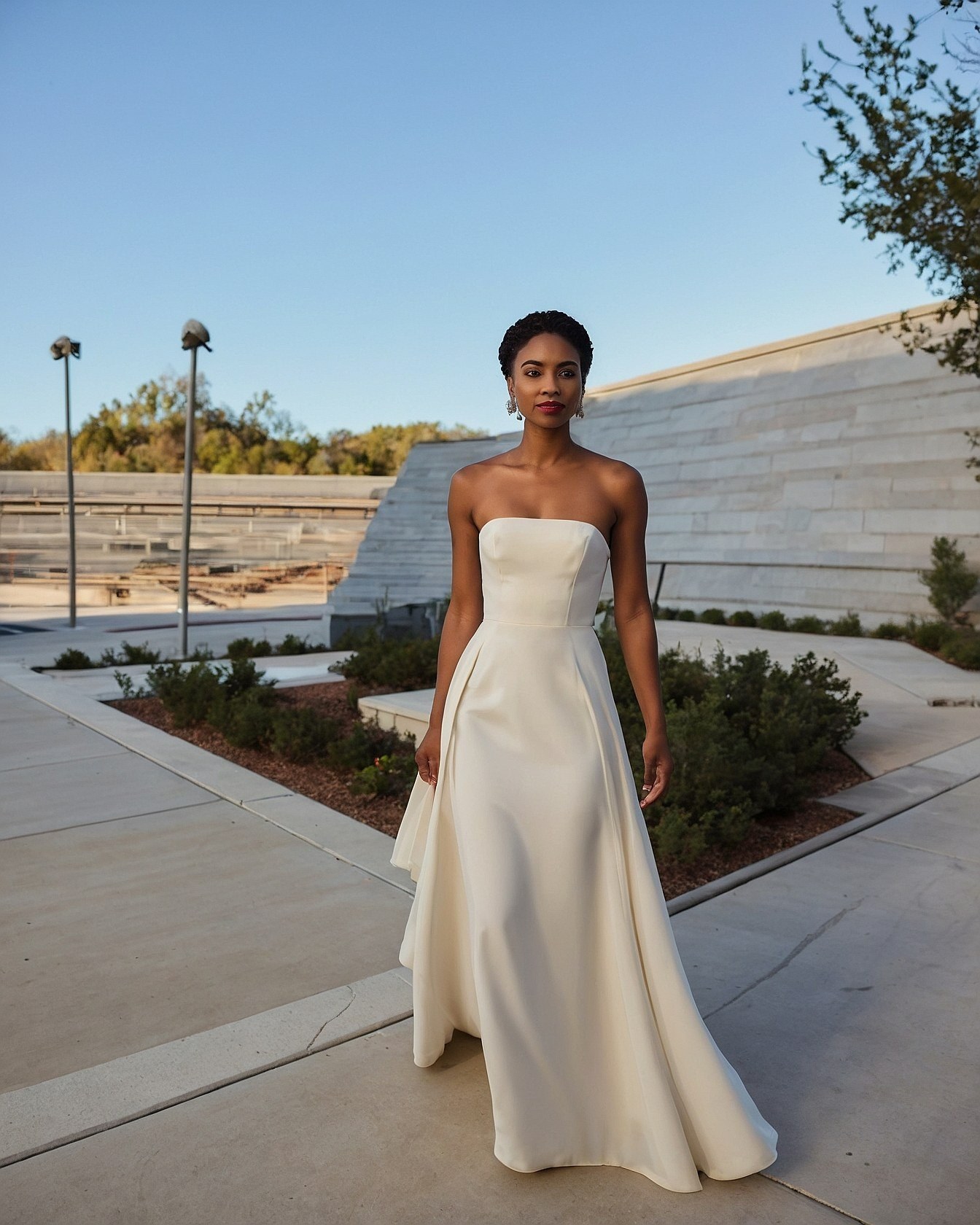 Ivory Strapless Gown Against Geometric Architecture