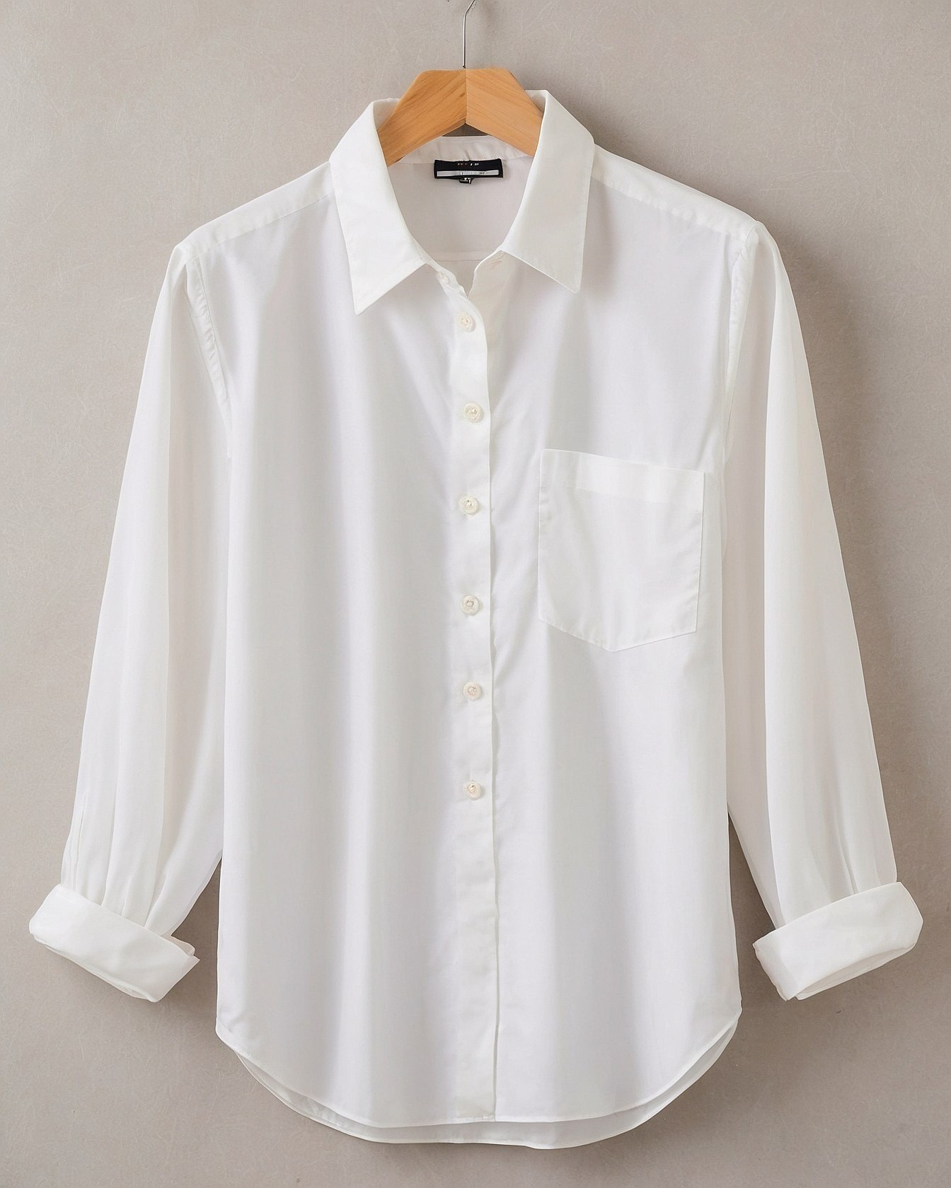 Crisp White Shirt with Rolled Sleeves Against Grey