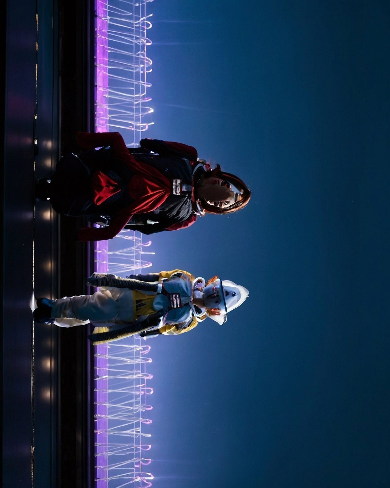 Neon illuminated metallic astronaut suits glowing against midnight backgrounds