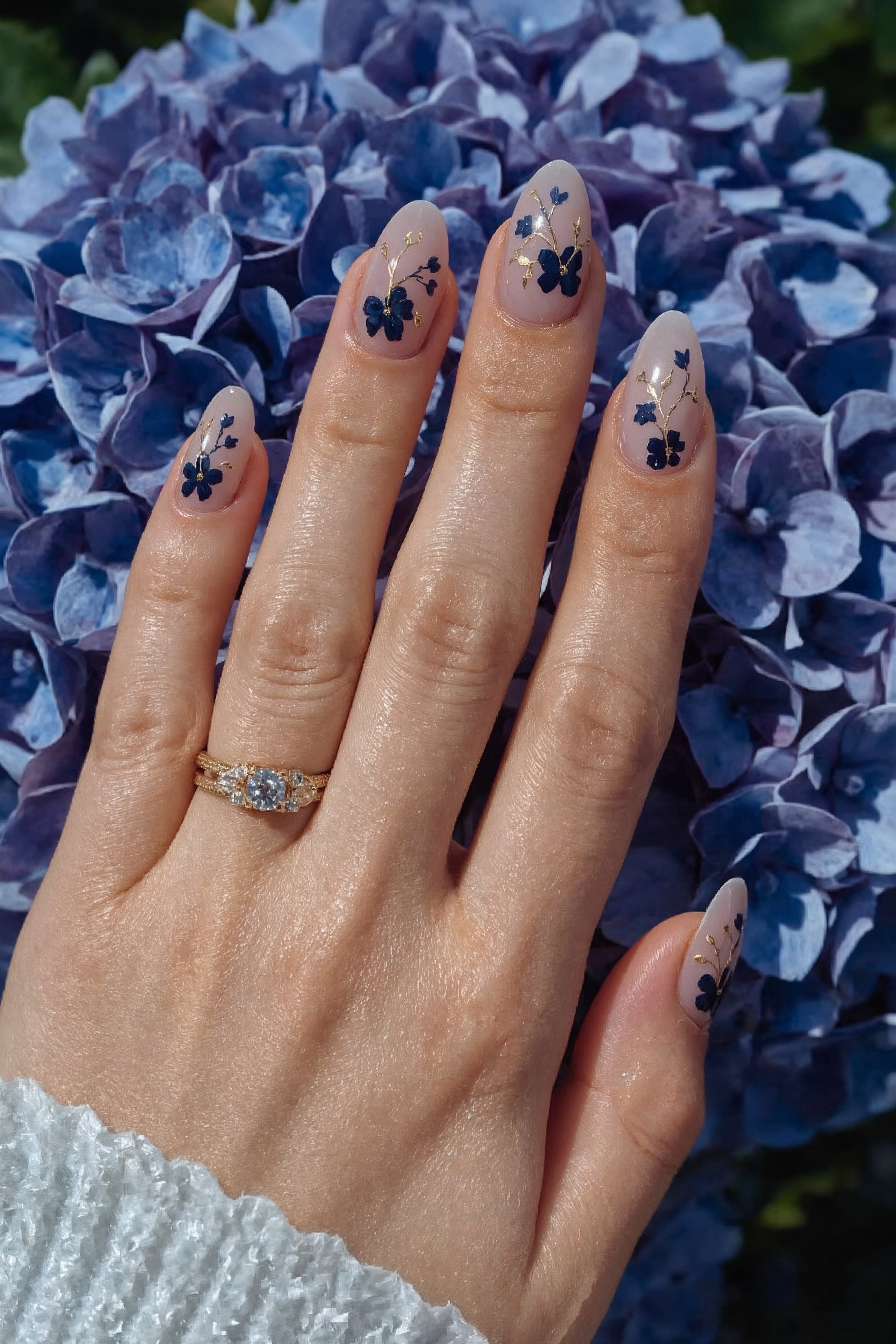 Spring Nude Almond Nails: Blue Floral & Gold Flake Trend