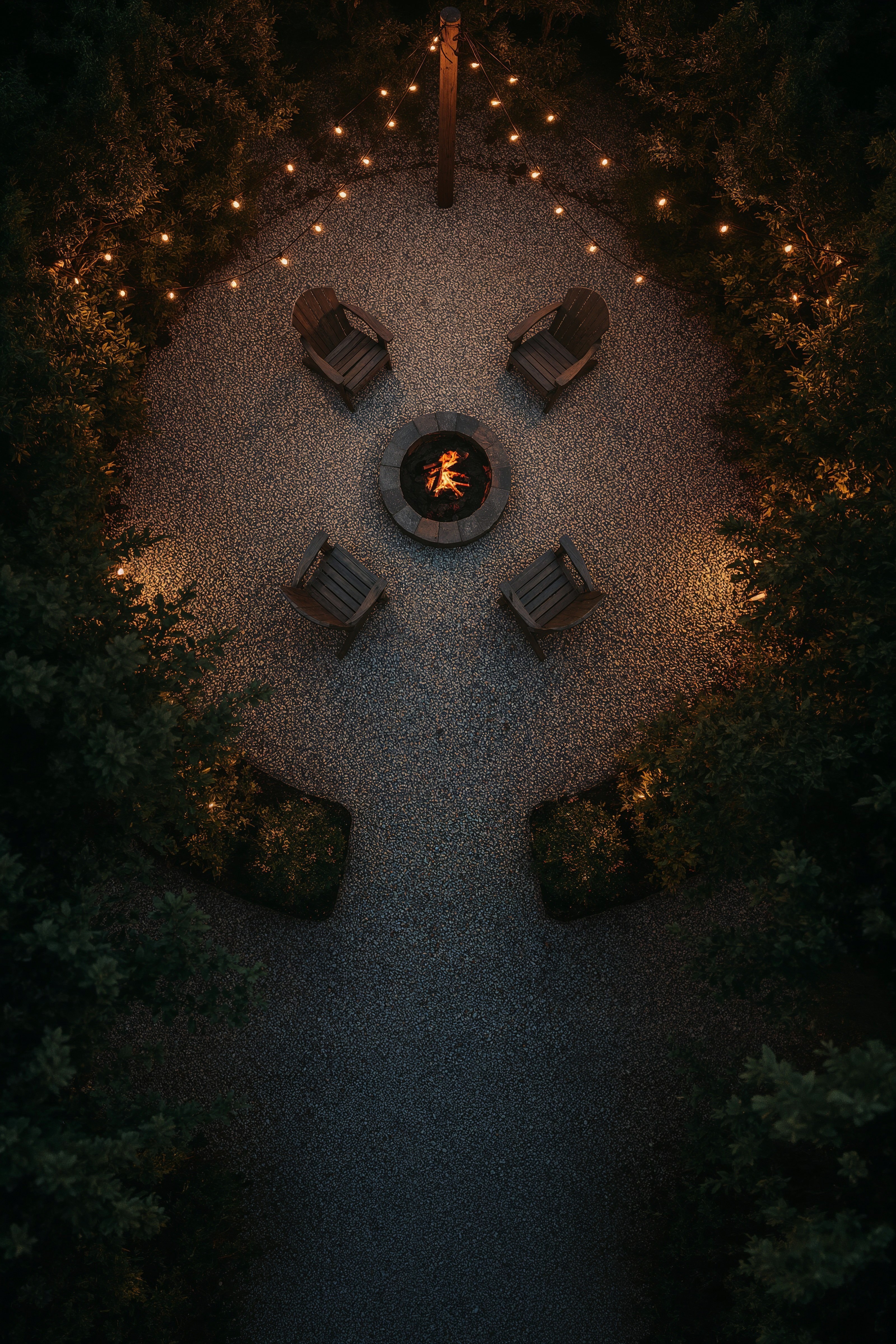 Cozy Fire Pit Area: String Lights & Gravel Backyard Retreat