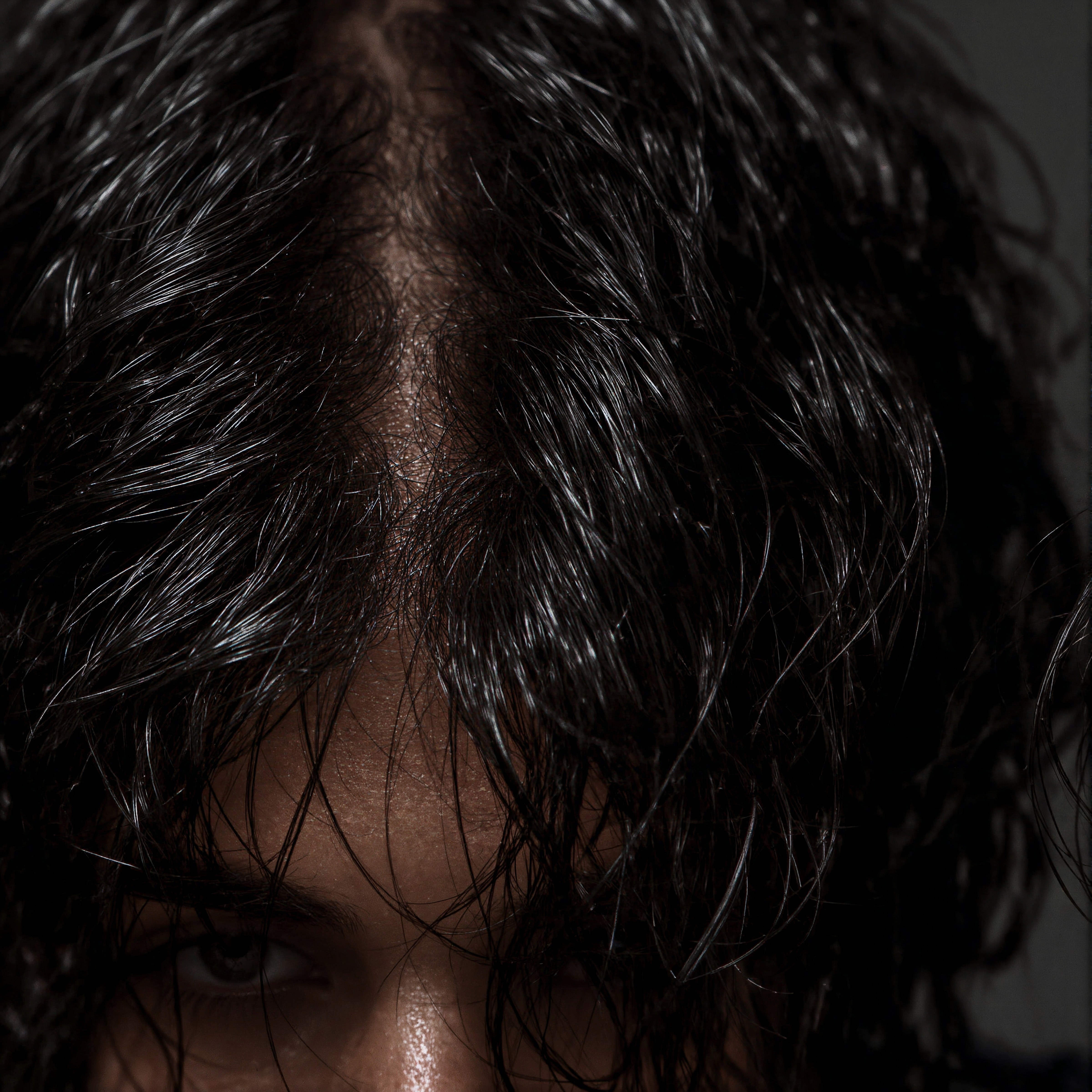 Wet Look Waves: Slicked Haircut with a Modern Middle Part