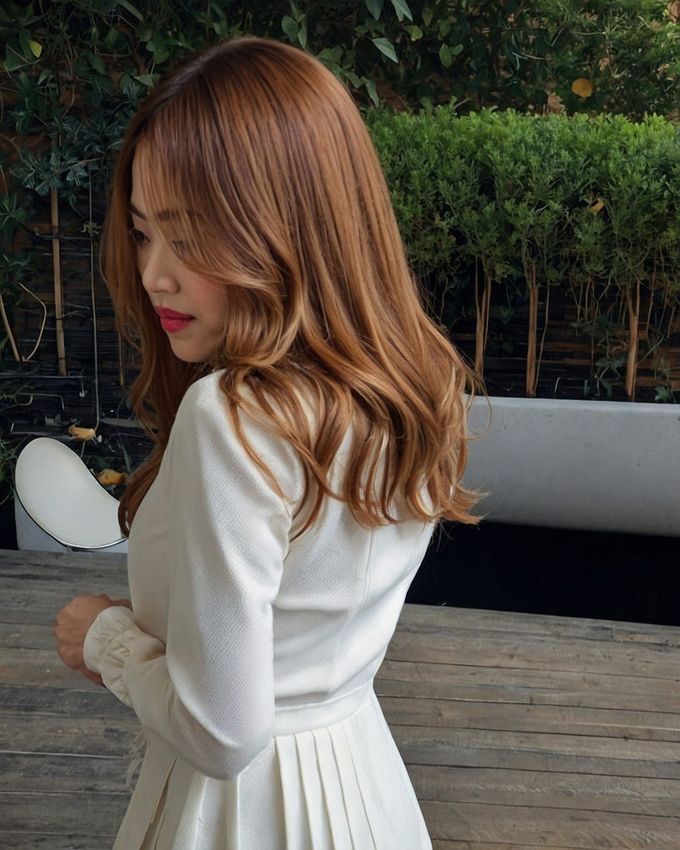 Close-up of textured ivory dress with pleated skirt